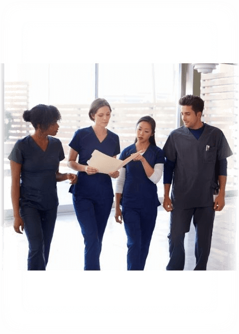 Healthcare Colleagues Discussing Notes in Hospital Corridor