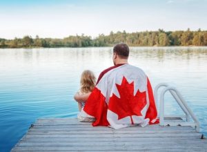 Father and Daughter Wrapped in Large Canadian Flag