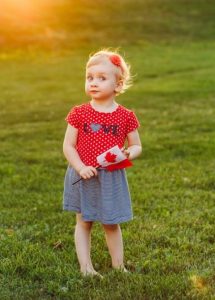 baby toddler girl holding Canadian flag