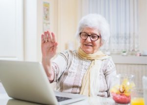 senior woman waving hand