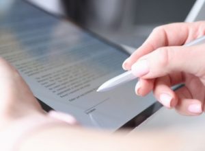 Woman Hand Holds Stylus and Puts an Electronic Signature