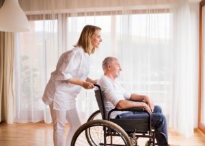 Nurse and Senior Man in Wheelchair