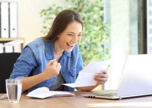 Excited entrepreneur girl reading a letter